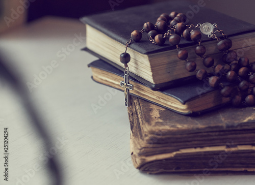 Fotomural The rosary beads on Catholic Church liturgy books.