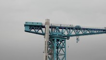 Panning To The Right Along The Top Of The Titan Crane, A 150 Foot High Cantilever Structure, On The Clyde Riverside At Clydebank. 