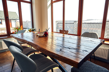 Interior of modern house, dining room with wooden table