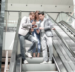 Wall Mural - employees of the company looking at the screens of smartphones