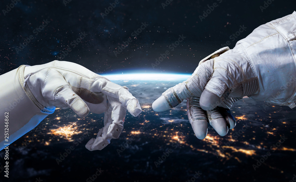 Astronaut and robot hands in the space. Earth planet on the background. Communication and technology. Cities lights. Elements of this image furnished by NASA - obrazy, fototapety, plakaty 