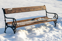 Old Rusty Vintage Empty Bench In Snow Covered Park