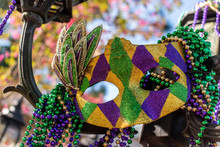 Outdoor Mardi Gras Beads And Mask On Light Post In Sunshine