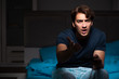 © Elnur - Young man playing computer games at night in bed