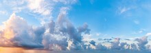 Twilight Sunset. Panorama Of Cloudy Sky With Colorful Clouds From Blue To Orange. High Resolution Panoramic Sky. Cumulus Formation.