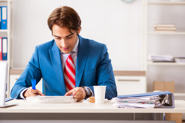 Wall Mural - Man having meal at work during break