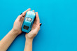 © 9dreamstudio - Car insurance concept. Safety of auto. Car toy in female hands on blue background top view copy space