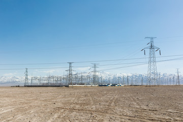 Wall Mural - transformer substation with snow mountains