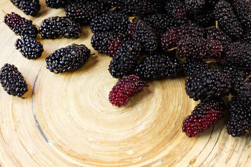 Wall Mural - The mulberry fruit in white bowl on wood table.