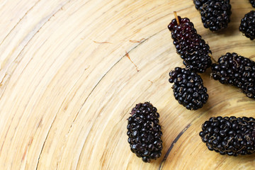 Wall Mural - The mulberry fruit in white bowl on wood table.