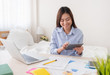 © weedezign - Asian freelancer using tablet while working with laptop on table in bedroom at home.Work at home concept.work from home concept.