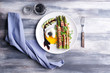 © Pixel-Shot - Plate with bacon wrapped asparagus and egg on wooden table