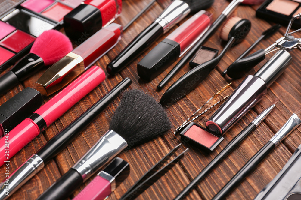 Professional makeup cosmetics with accessories on wooden background