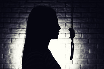 Wall Mural - Silhouette of woman with noose on dark background. Suicide concept