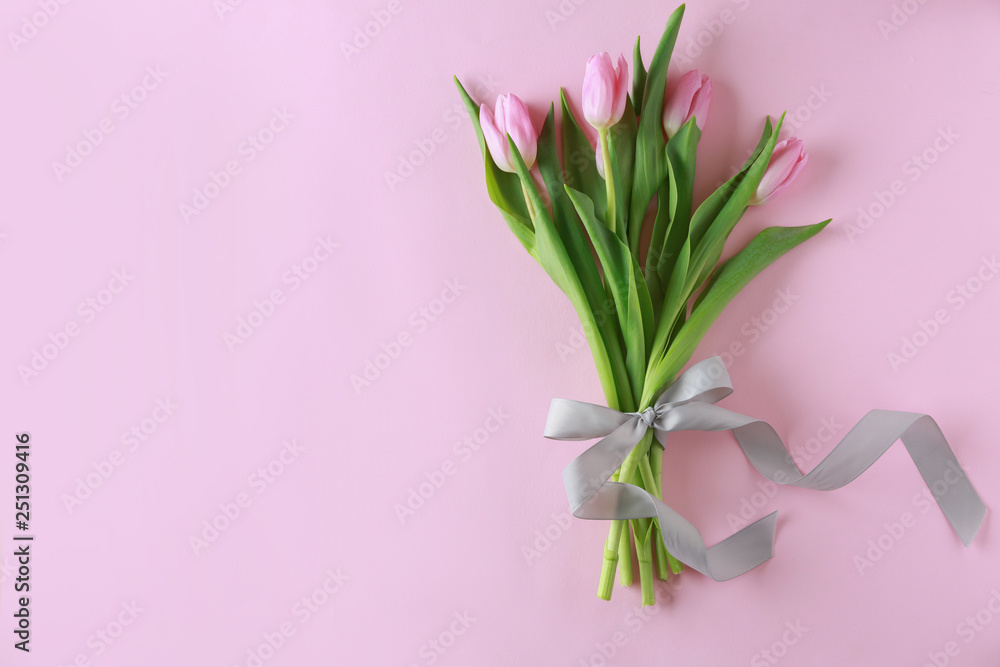 Bouquet of beautiful tulips on color background