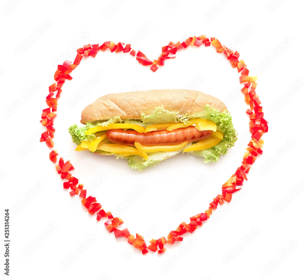 Tasty hot dog in heart-shaped frame on white background