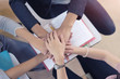 © inews77 - Teamwork concept, students putting hands together.