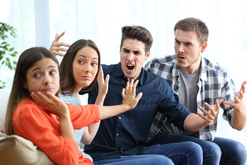 Two women and men arguing at home