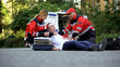 © motortion - Ambulance medic giving painkiller to man lying on road, qualified emergency care