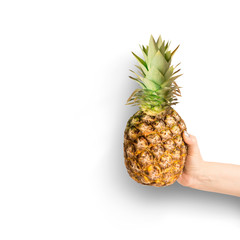 Female hand holding pineapple at white background. Summer tropical fruits concept. Isolated. Copy space for your design