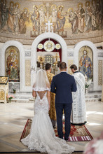 The Bride And The Groom Are Standing In The Chapel In Front Of The Two Chaplains.