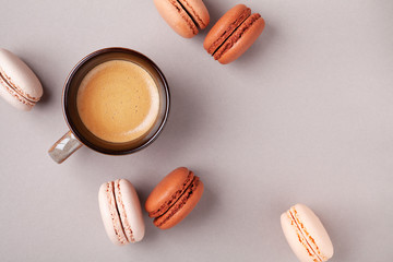 Morning cup of coffee and dessert macaron or macaroon top view. Flat lay style.