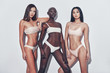 © gstockstudio - Proud to be beautiful. Three attractive mixed race women looking at camera while standing against grey background