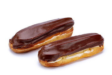 Traditional french dessert. Isolated two eclairs with custard and chocolate icing on white background. Sweet pastry products