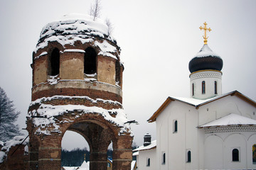 Ruins of ancient Assumption Cathedral and orthodox church of white stone behind