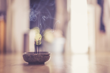 Smoking and smelling joss sticks at home, feng shui; Copy space