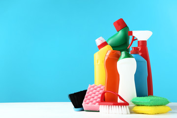 Wall Mural - Bottles with detergent and cleaning tools on wooden table