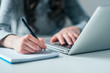 © bnenin - Business and education concept. Using laptop and writing in notebook.