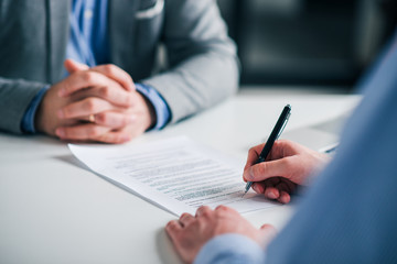 Wall Mural - Signing contract on a meeting, close-up.