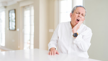 Sticker - Handsome senior man at home touching mouth with hand with painful expression because of toothache or dental illness on teeth. Dentist concept.