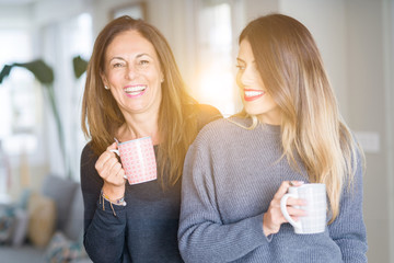 Sticker - Beautiful family of mother and daughter together drinking a cup of coffee at home