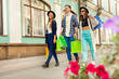 © Sergey Novikov - Guy and girls with shopping bags during travel