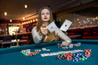 © RomanR - Young woman throwing playing cards in casino