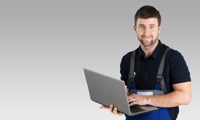 Wall Mural - Portrait of cheerful Handsome  mechanic  on background