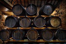 Rows Of Alcoholic Drums In Stock. Distillery. Cognac, Whiskey, Wine, Brandy. Alcohol In Barrels