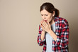 © New Africa - Woman suffering from cough on color background. Space for text