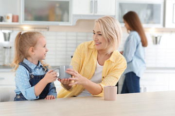 Canvas Print - Mature woman, her grandchild and daughter spending time in kitchen