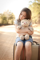 Wall Mural - Little Girl with Ragged Teddybear and Suitcase - Poverty, Homelessness, Runaway Child