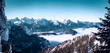 panorama of a winter mountain landscape with high fog in the valley