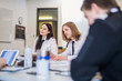 © Cavan Images - Pilot trainees looking away while sitting at desk in classroom