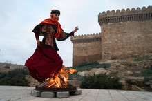 Traditional Azerbaijani Novruz Holiday Celebration With Beautiful Girl Jumping Over The Fire,