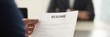 © fizkes - Boss holding resume cv paper interviewing vacancy candidature panoramic image