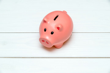  Piggy Bank stands on a white wooden background