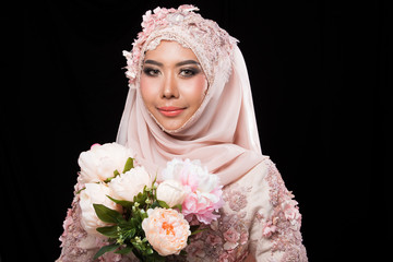 Asian Charming muslim arabic bride in Lace Bead Embroidery Sweet Pink old rose wedding dress and hijab headscarf, close-up on Fashion Make up Eyes Face, studio lighting black background isolated.