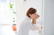 © Halfpoint - A young woman putting on a make-up in the morning in a bathroom.