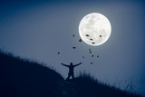 Fototapeta Na sufit - Copy space man raise hand up on top of mountain and birds fly with full moon abstract background.